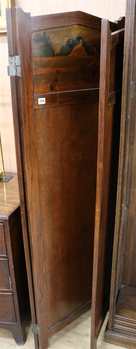 An early 20th century oak three fold screen with stencilled decoration W.135cm